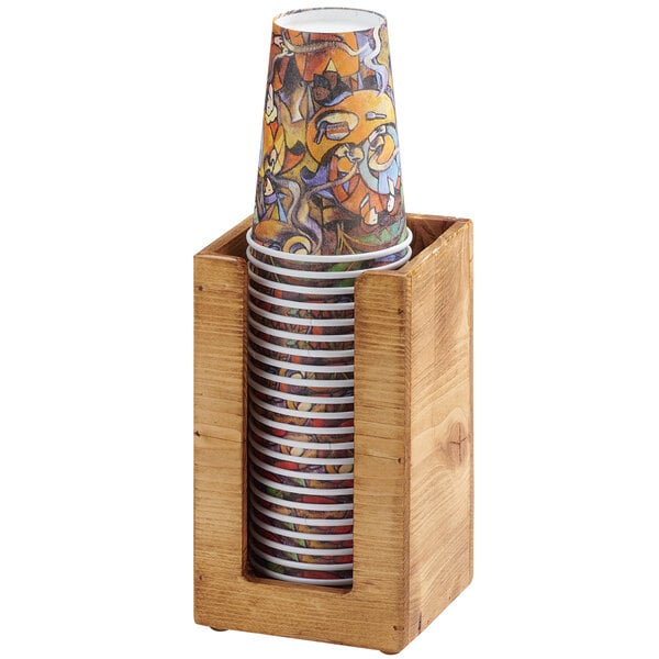 A Cal-Mil Madera countertop cup and lid organizer with paper cups in a wooden holder.