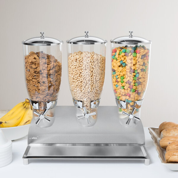 A Cal-Mil stainless steel cereal dispenser with cereal in it.