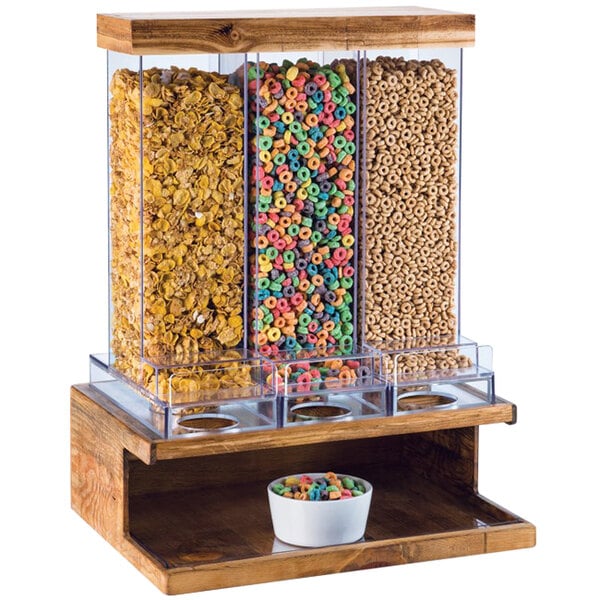 A Cal-Mil Madera rustic pine cereal dispenser with a variety of cereals.