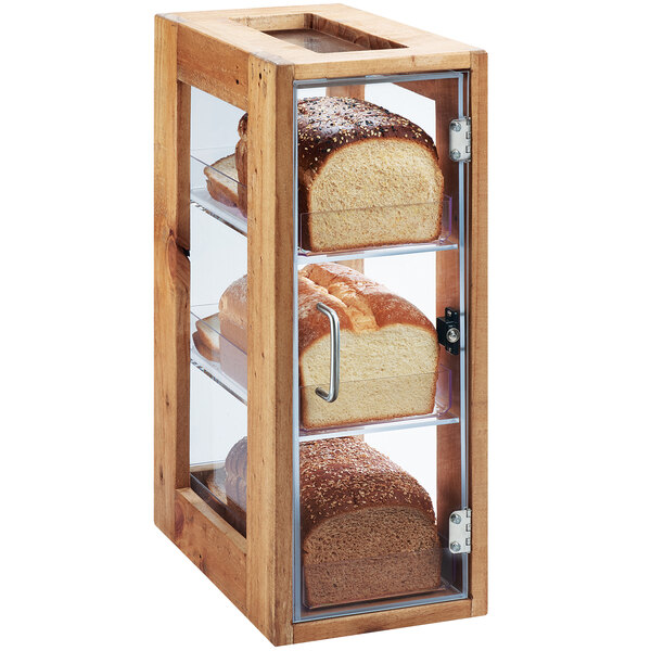 A wooden Cal-Mil bread display case with three loaves of bread inside.