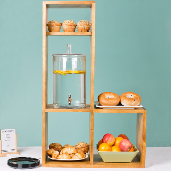 A Cal-Mil Madera rustic pine display stand with food on it.