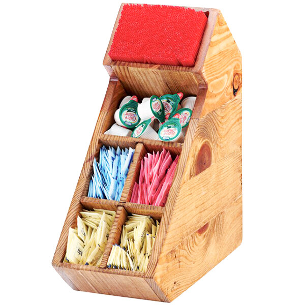 A Cal-Mil Madera rustic pine condiment display with removable dividers holding a variety of stir sticks in a wooden box.