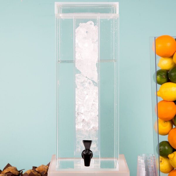 A clear plastic Cal-Mil beverage dispenser with ice inside.
