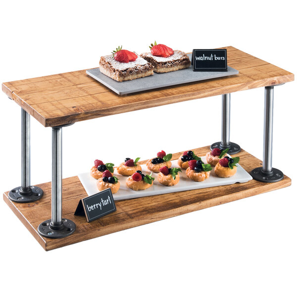 A wooden shelf riser with food on it.