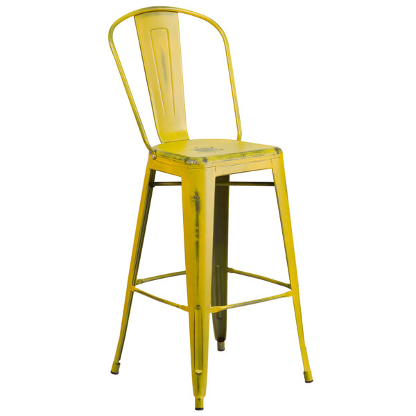 A yellow metal bar stool with a back and drain hole seat.