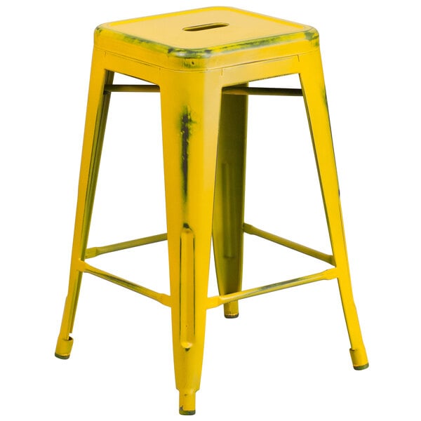 A yellow Flash Furniture metal counter height stool with legs.