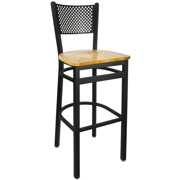 A BFM Seating black metal bar chair with a natural wooden seat.