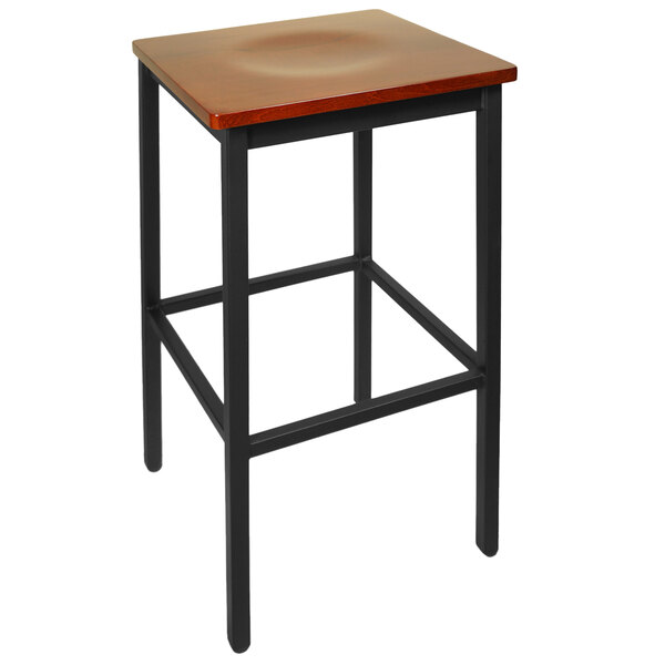 A BFM Seating black metal bar stool with a cherry wood seat.