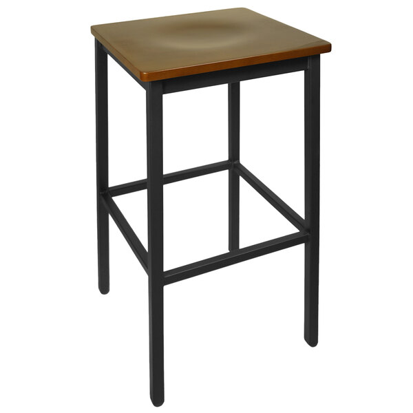 A BFM Seating Trent black metal bar stool with a walnut wood seat.