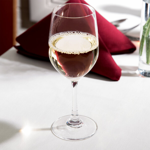 A Spiegelau Vino Grande white wine glass on a table.