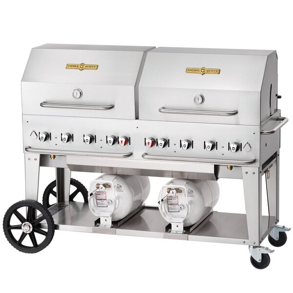 A Crown Verity stainless steel outdoor club grill with two propane cylinders on wheels.