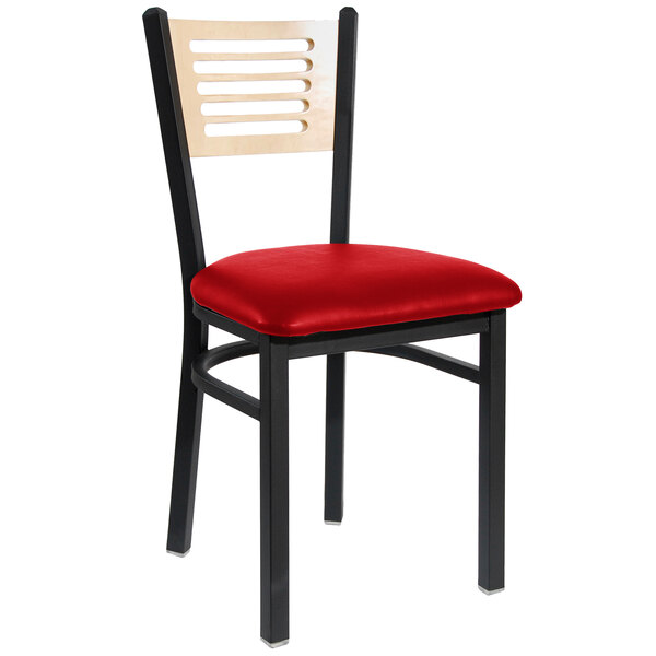 A BFM Seating black metal side chair with a red vinyl seat and natural wood back with a red cushion on the seat.