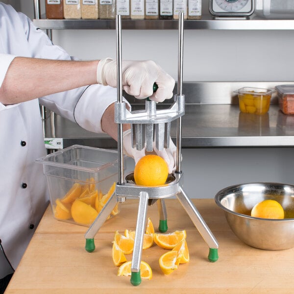 A person using a Garde Wedge Cutter to cut up an orange.