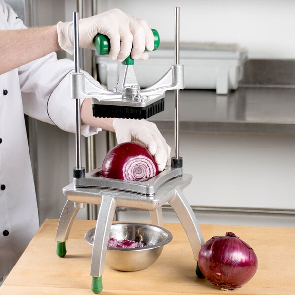 A hand using a Garde XL Heavy-Duty Large Vegetable Dicer to chop a red onion over a bowl.