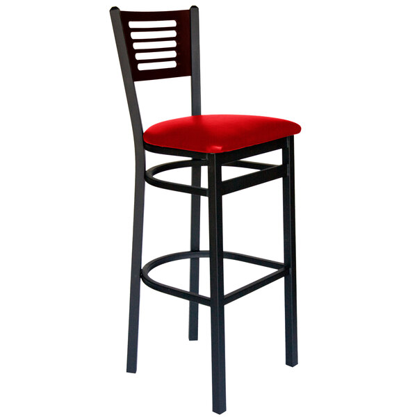 A BFM Seating black metal bar stool with a red vinyl seat.