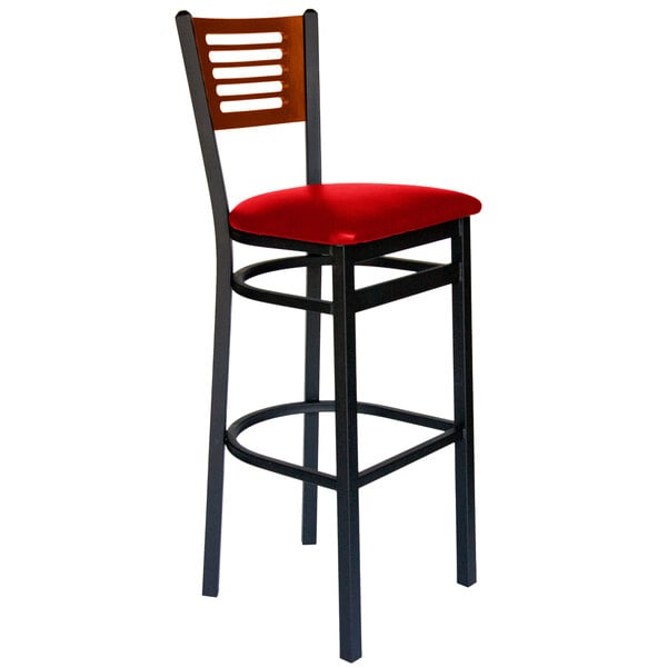 A black metal BFM Seating bar height chair with a red vinyl seat and cherry wood back.