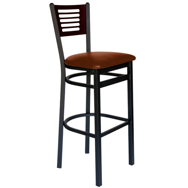 A BFM Seating black metal bar stool with a walnut wood back and light brown vinyl seat.