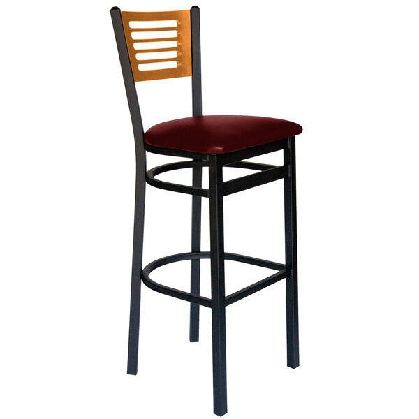 A BFM Seating black metal bar chair with a burgundy seat and wooden back.