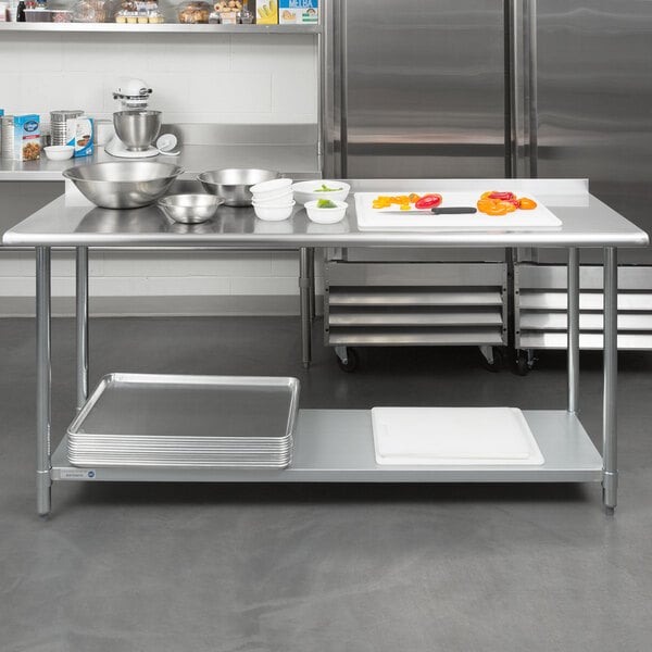 A Steelton stainless steel work table with an undershelf in a kitchen with food on it.
