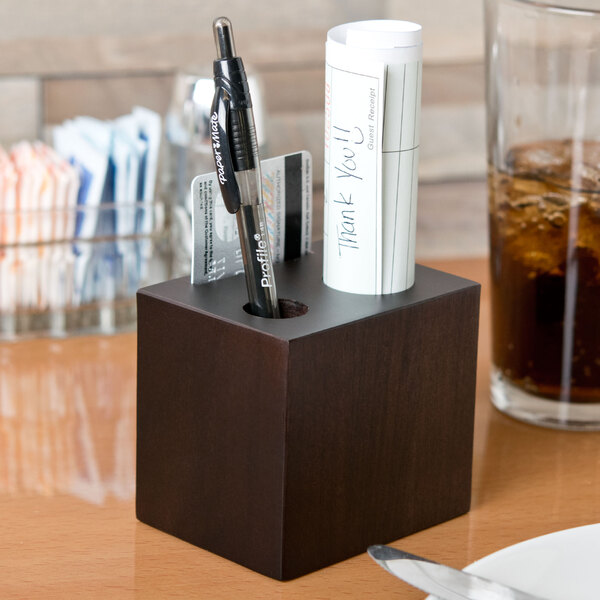 An American Metalcraft espresso block check presenter with pens and pencils inside.