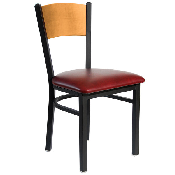 A BFM Seating black metal side chair with a natural wood back and burgundy vinyl seat.