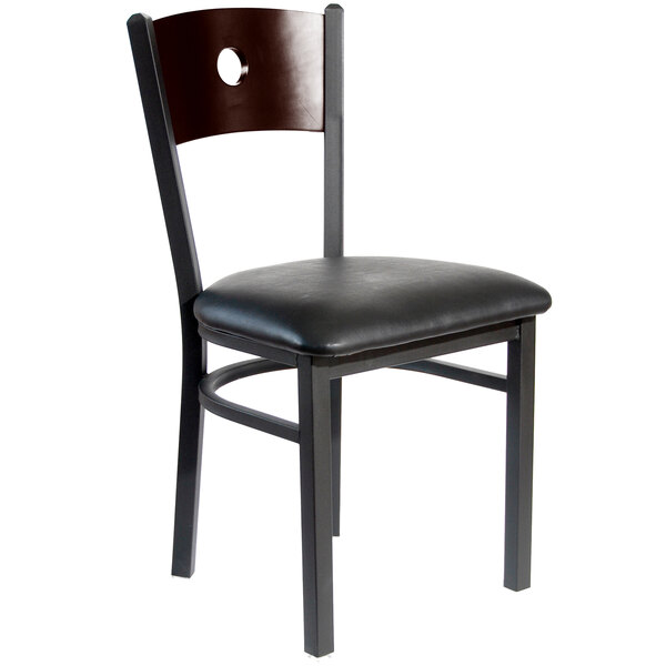A black BFM Seating restaurant chair with a walnut wooden back and black cushion.