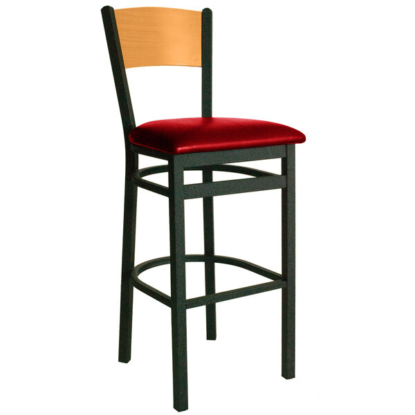 A BFM Seating black metal bar stool with a red cushion.