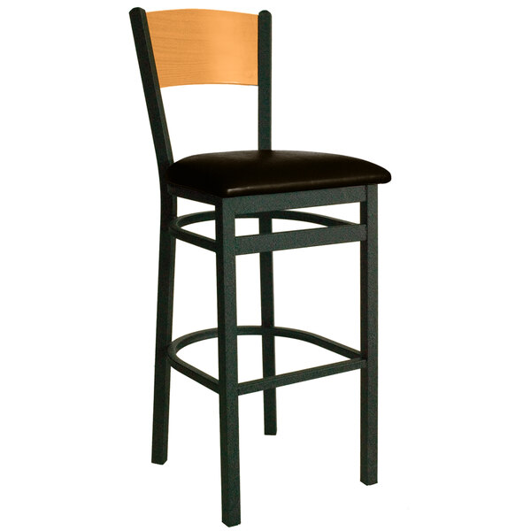 A BFM Seating black metal bar chair with a dark brown vinyl seat and natural wood back.