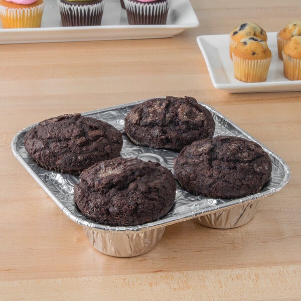A D&W Fine Pack jumbo muffin pan filled with muffins on a table.