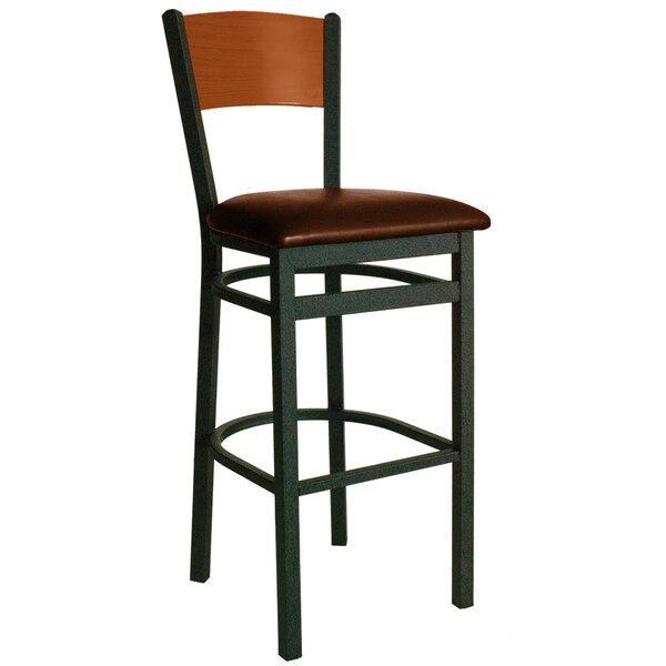 A BFM Seating black metal bar chair with a light brown seat.