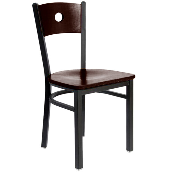 A BFM Seating black metal side chair with a walnut wooden back and seat.