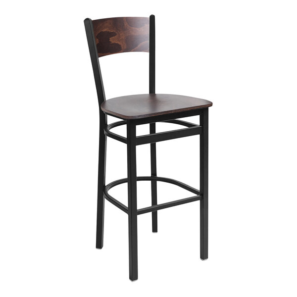 A BFM Seating black metal bar stool with a wooden back.