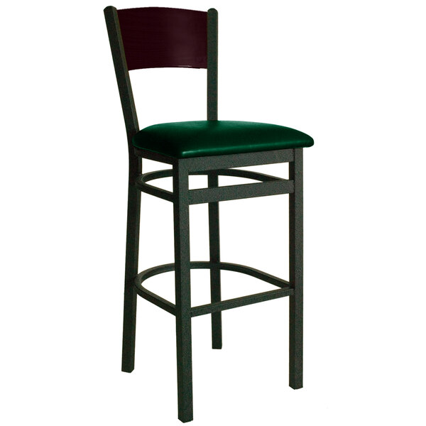 A BFM Seating black metal bar height chair with green vinyl seat.