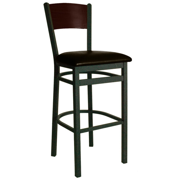 A BFM Seating black metal bar stool with a dark brown vinyl seat and a walnut finish wooden back.
