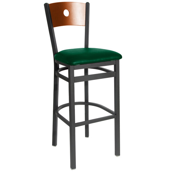 A BFM Seating black metal restaurant bar stool with green vinyl seat.