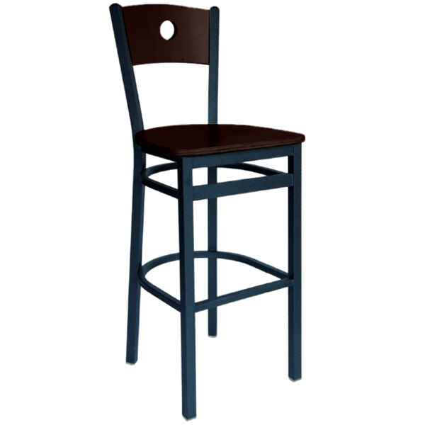 A black metal restaurant bar stool with a wooden seat and back.