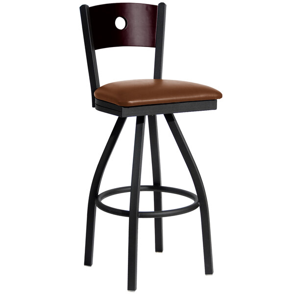 A BFM Seating black metal bar chair with a mahogany wood back and light brown vinyl seat.