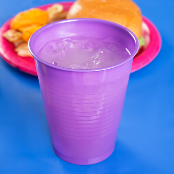 A purple plastic cup with ice in it.