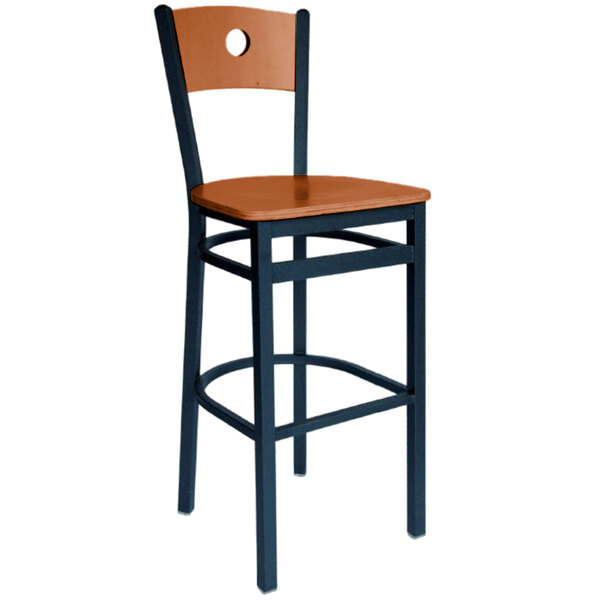 A BFM Seating black metal bar stool with a cherry wooden seat and back.