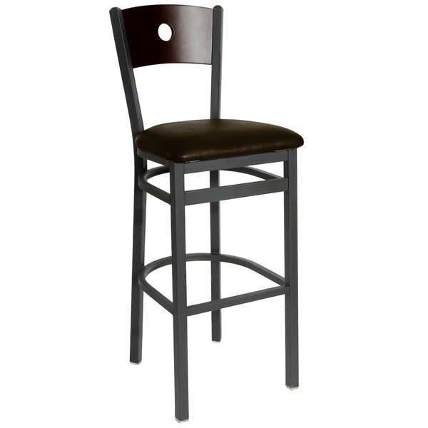 A BFM Seating black metal bar stool with a dark brown vinyl seat and walnut back.