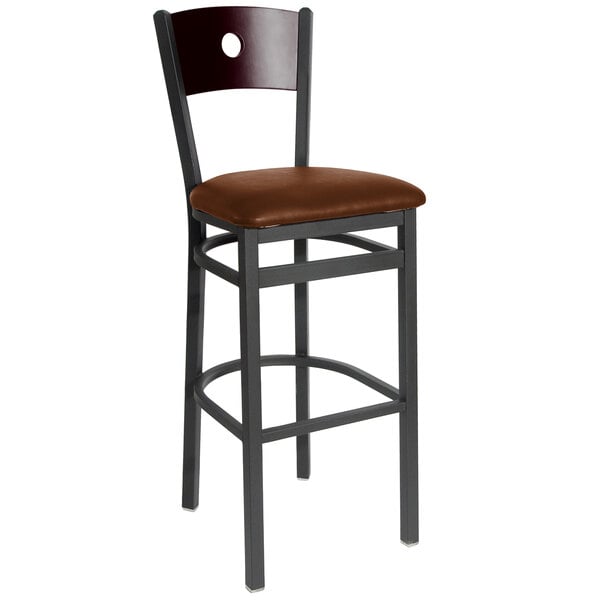 A BFM Seating black metal bar stool with a mahogany wooden back and light brown cushion.