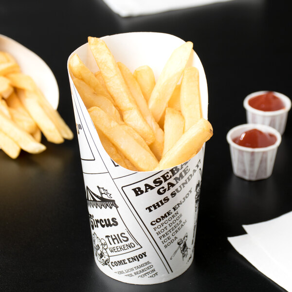 An American Metalcraft paper French fry cup filled with French fries and ketchup.