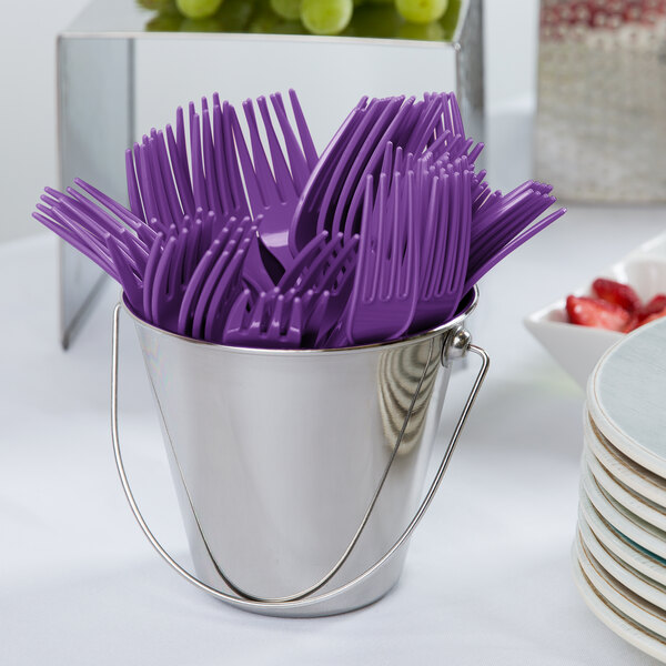 A bucket of amethyst purple plastic forks.