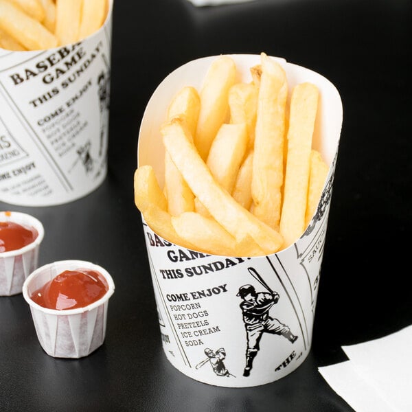 Two American Metalcraft paper French fry cups filled with French fries.