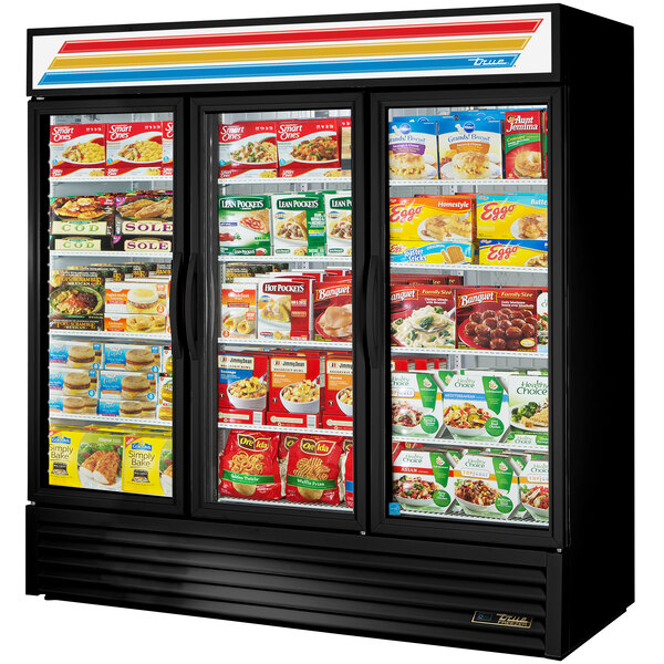 A black True glass door merchandiser freezer with food on the shelves.