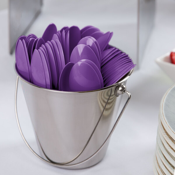 A bucket of amethyst purple Creative Converting plastic spoons.