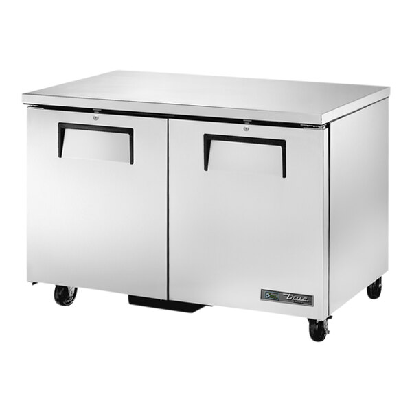 A True low profile undercounter freezer with stainless steel and black handles on wheels.