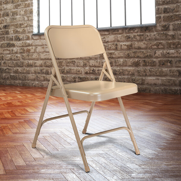 A beige National Public Seating metal folding chair.