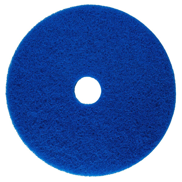 A blue Scrubble cleaning floor pad with a white center.