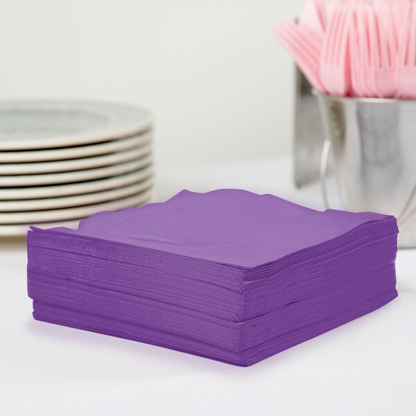 A stack of Creative Converting Amethyst Purple 3-Ply Luncheon Napkins.